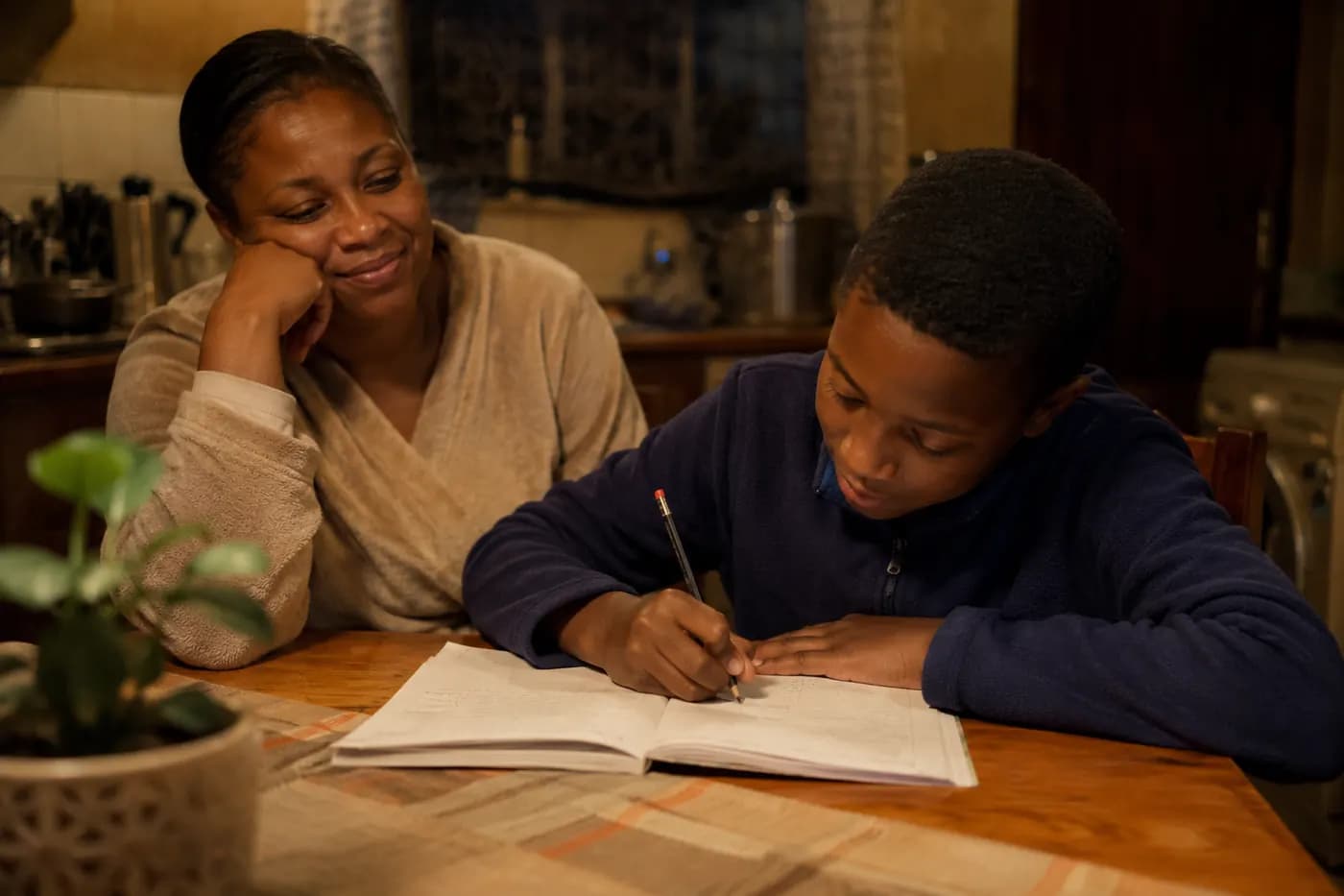 A mother watching her son work through a problem himself